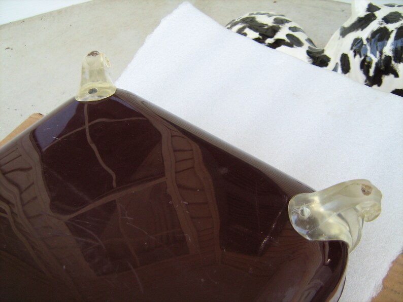 May include: A dark brown serving tray with clear plastic handles. The tray has a smooth, glossy finish and is rectangular in shape.