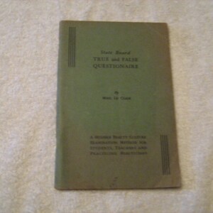 May include: A green book titled "Date Board TRUE and FALSE QUESTIONNAIRE by Max. 12 Class A MODERN BEAUTY CULTURE EXAMINATION METHOD FOR STUDENTS, TEACHERS AND PLACEMENT BOARDS"