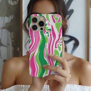 May include: A white phone case with a pink and green abstract swirl pattern. The case has a camera lens cutout.