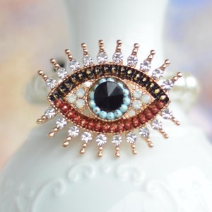 Broche místico de mau-olhado, broche de proteção de cristal brilhante, joia de broche de globo ocular de esmalte e strass, contas vermelhas e pretas, presente espiritual