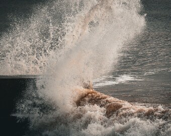 Dramatic photo download of wave breaking against harbour wall Devon England