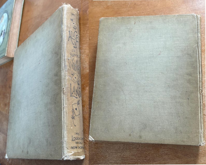 May include: Two antique books with light green covers. The spine of one book reads "Alice's Wonderland" with decorative illustrations and the publisher's name. The other book is lying flat, showing its cover.