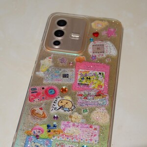 A detail close up of kawaii y2k girly resin phone case with holographic glittery effect and rhinestone details