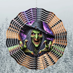 May include: A metal wind spinner with a green witch with long black hair and a pointed hat. The witch is reaching out with her claws. The background is a purple and black galaxy with stars. The wind spinner is made of metal and has a silver finish.