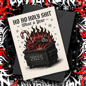 May include: A greeting card with the text "HO HO HOLY SHIT - What a Year -" features a dumpster on fire with a candy cane, gifts, and a Christmas ornament. The dumpster is labeled "2025". The card is on a black envelope with a snowflake design.