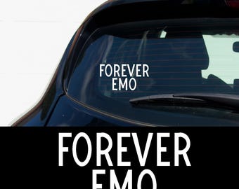 May include: White vinyl decal with the words "FOREVER EMO" in a bold, sans-serif font. The decal is shown on the rear window of a black car. The text is also displayed on a black background.