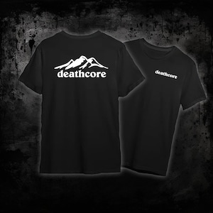 May include: Two black t-shirts with white text and mountain graphic. One shirt displays "deathcore" below a mountain range on the back. The other shirt has "deathcore" on the front. Both shirts are short-sleeved.