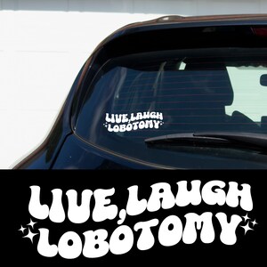May include: White vinyl car sticker with the text "Live, Laugh, Lobotomy" in a retro font with stars on either side.