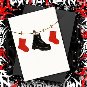 This minimalist Christmas card features two bright red stockings and a black combat boot hanging on a clothesline — perfect for goths, punks, and alternative holiday lovers. Printed on high quality matte cardstock, this card is blank inside so you can write your own message. A fun and edgy way to celebrate the season while showing off your alternative style. Great for friends, bandmates, or anyone who would rather hang boots than stockings.