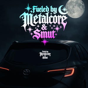 May include: A car rear window displays a decal with the text "Fueled by Metalcore & Smut" in a stylized font, with a gradient of blue, teal, and pink. The background features a full moon and a dark night sky.