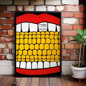 Op de afbeelding: Een zwart ingelijste poster met een rode mond en witte tanden. De mond is gevuld met gele en zwarte maïskorrels. De tekst op de poster luidt "Sweet Corn Festival summer picnic herman miller august 21, 1970".
