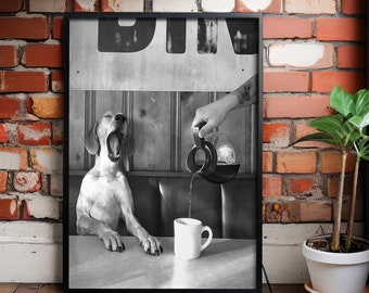 Puede incluir: Foto en blanco y negro de un perro bostezando en una mesa con una taza de café. Una mano vierte café de una jarra en la taza. El texto "DIN" es visible en un letrero sobre el perro.