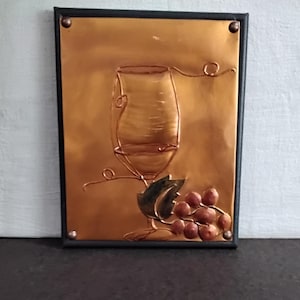 Wine glass copper embossed art. Minimalist 8 x 10 design with table top and wall mounting options mounted on a gray painted canvas frame.