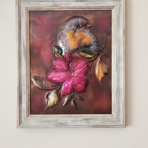 Bluebird and flower copper embossed art.  Includes tabletop and wall mounting options in a silver toned 8 x 10 frame.