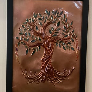 Tree of life copper embossed art. Mounted in a black frame with tabletop and wall mounting options.
