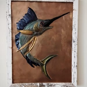 Hand copper embossed marlin. 9x12 Copper embossing with tabletop and wall mounting options in a distressed white frame.