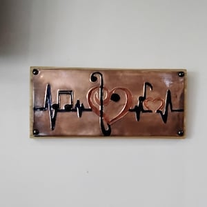 Music Heartbeat copper embossed art. Dark blue heartbeat with table top and wall mounting options. Mounted on a 5 1/2 ×12 cedar plank.