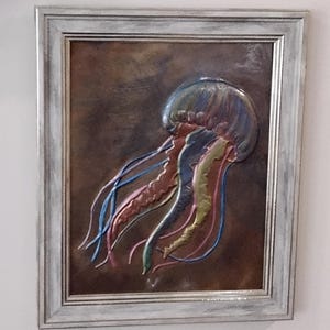 Jellyfish copper embossed art. Includes tabletop and wall mounting options in a silver toned 8 x 10 frame.