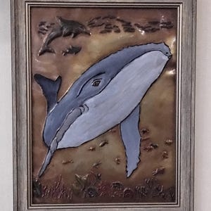 Whale copper embossed art. Mounted in a 9x12 brown toned frame with tabletop and wall mounting options.