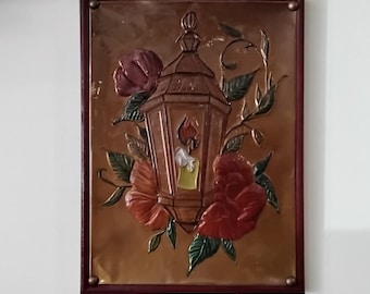 Lantern and flowers copper embossed art. Cranberry painted 9x12 canvas frame with table top and wall mounting options.