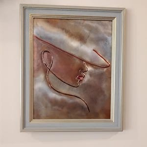 Woman copper embossed art.  Includes tabletop and wall mounting options in a sage green and gold toned 8 x 10 frame.