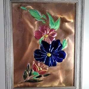 Flowers copper embossed art. Mounted in a 9x12 brown toned frame with tabletop and wall mounting options.