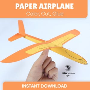 Può includere: Un aeroplano di carta composto da elementi in carta arancione e gialla, con una graffetta metallica sul muso e il testo PAPER AIRPLANE Color, Cut, Glue e B&W version PDF. Il design include un'ala principale, una fusoliera e una deriva.