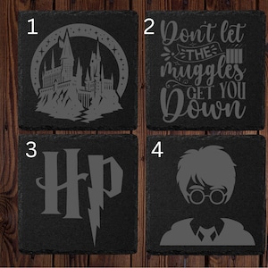 May include: Four square black slate coasters with etched designs. Designs include a castle, the phrase "Don't let the muggles get you down", the letters "HP" with a lightning bolt, and a silhouette of a boy with glasses.