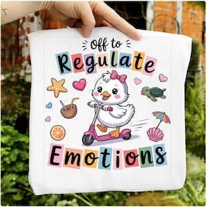 May include: White tote bag featuring a cartoon duck on a pink scooter, with the text "Off to Regulate Emotions." The design includes a starfish, hearts, a turtle, and other beach-themed illustrations in a colourful palette.
