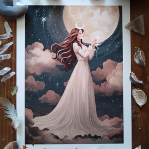 May include: A watercolor painting of a woman in a white dress standing in front of a full moon. She is holding a small star in her hand and has a crescent moon on her forehead. The background is a dark blue sky with clouds and stars.