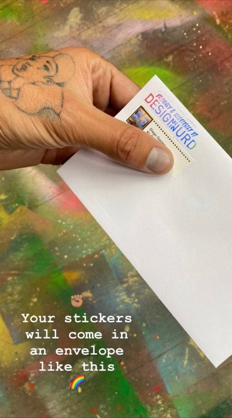 May include: A white envelope with a sticker on the front that says "DESIGNED & ILLUSTRATED BY DESIGWURD". The text "Your stickers will come in an envelope like this" is written below the envelope. A rainbow emoji is below the text.