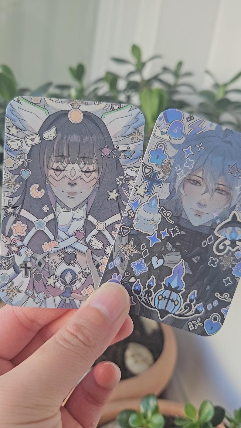 Front facing photocards of Genshin Impact's Columbina (right) and Flins (left)