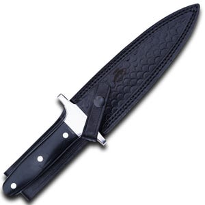 May include: A black dagger with a silver blade and a black handle with three white rivets. The dagger is in a black leather sheath with a textured pattern and a snap closure.