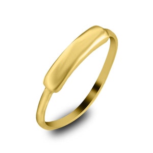 May include: A simple gold band ring with a flat, rectangular top.