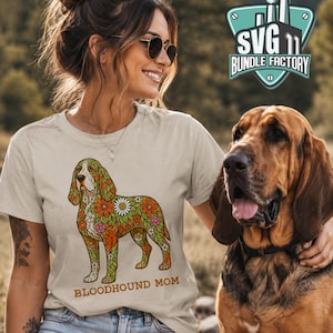 May include: Beige t-shirt with a colorful floral design of a Bloodhound dog and the text "BLOODHOUND MOM". The dog has orange, green, and white floral patterns. The image also includes a logo that says "SVG 11 BUNDLE FACTORY".