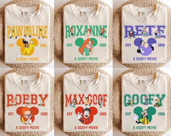 May include: Six cream-colored t-shirts with a cartoon character and text on each. The text on the shirts reads "Powerline", "Roxanne", "Pete", "Bobby", "Max Goof", and "Goofy". Each shirt has a cartoon character from the movie "A Goofy Movie" and the text "A Goofy Movie" at the bottom.