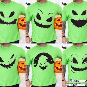 May include: Lime green Gildan T-shirts with black face designs. Each shirt features a different spooky face, ideal for Halloween. The shirts are displayed with carved orange pumpkins and bat decorations.