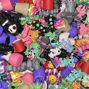 May include: A colorful assortment of 3D-printed figurines, including ice cream cones, bats, mugs, and flower-shaped objects. The collection features a variety of colors, such as pink, black, green, and purple, creating a playful and whimsical aesthetic.