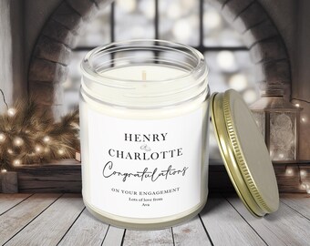 May include: A white candle in a glass jar with a gold lid. The label reads "Henry Charlotte Congratulations on your engagement Lots of love from Ava".