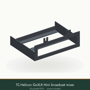 May include: A dark gray 3D printed PETG mounting bracket for a TC-Helicon GoXLR Mini broadcast mixer. The frame features a rectangular open design with two small vertical tabs on the front edge. The text TC-Helicon GoXLR Mini broadcast mixer 3D printed PETG screws included is visible below the object.
