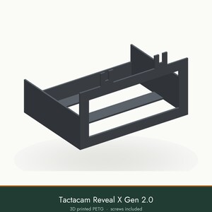 May include: A dark gray, rectangular 3D printed PETG mounting bracket for a Tactacam Reveal X Gen 2.0 camera. The frame features an open-front design with two vertical tabs on the top edge and a horizontal support bar across the center base.