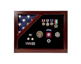May include: A wooden shadow box with a folded American flag, military medals, and patches. The shadow box has a black velvet background.
