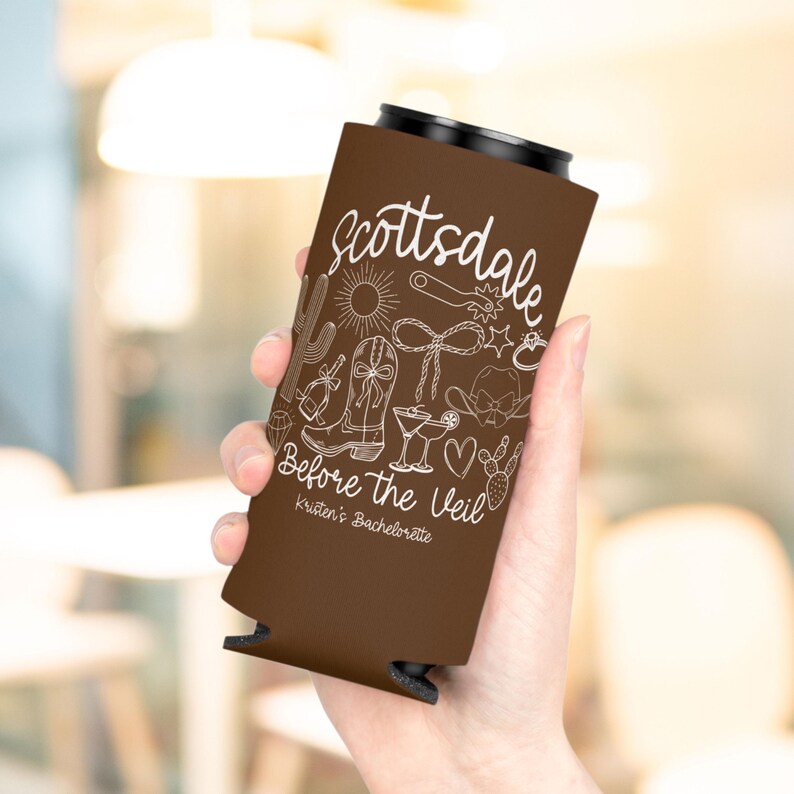 May include: A brown can cooler with white line art of cowboy boots, a cactus, and the word "Scottsdale." The text "Before The Veil" is also displayed. The cooler is designed for a bachelorette party.