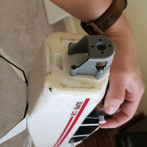 May include: White and red airplane model with the text "SUPER CUB" printed on the side. The model has a gray motor mount and a white propeller.