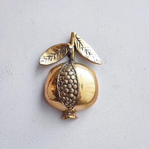 Vintage pomegranate with seeds, brass pomegranate on a leafy twig, half pomegranate, golden fruit sculpture