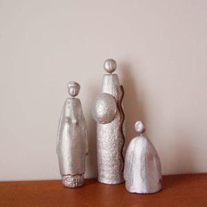 Abstract family sculptures, set of three, metal sculptures of man, woman and child, set of three, ancient figurines