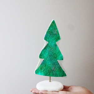 Sparkling christmas tree, plastic christmas tree on a white pebble, bright green xmas tree miniature, modern xmas decor, quirky xmas tree