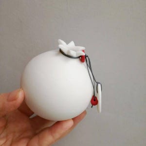 Porcelain white pomegranate, lucky pomegranate in pure white with red beads and doughtnut charm, life size white pomegranate