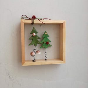 Chistmas tree wall hanging, xmas fir trees with baubles, ceramic xmas tree miniatures in wooden frame, natural wood frame with xmas trees