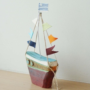 Ceramic sailing boat with colourful flags, stoneware clay boat sculpture with wire mast and fabric flags, greek pottery boat
